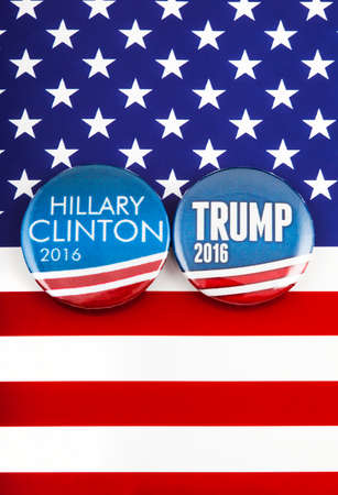 LONDON, UK - MARCH 3RD 2016: Hillary Clinton and Donald Trump pin badges over the American flag, symbolizing their battle to become the next President of the United States, 3rd March 2016.のeditorial素材