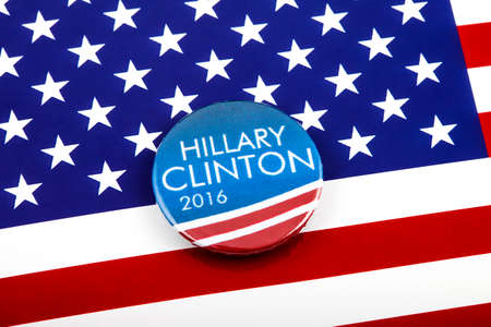 LONDON, UK - MARCH 3RD 2016: A Hillary Clinton 2016 pin badge over the US flag symbolising her campaign to become the next President of the United States, 3rd March 2016.のeditorial素材