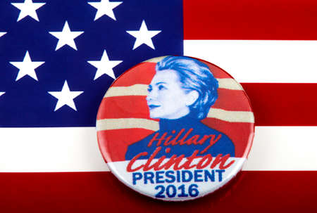 LONDON, UK - MARCH 3RD 2016: A Hillary Clinton 2016 pin badge over the US flag symbolizing her campaign to become the next President of the United States, 3rd March 2016.のeditorial素材