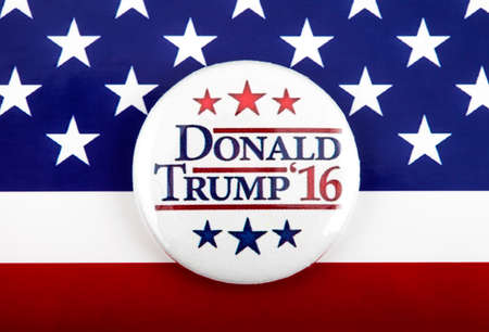 LONDON, UK - MARCH 3RD 2016: A Trump 2016 pin badge over the US flag symbolizing the Donald Trump campaign to become the next President of the United States, 3rd March 2016.のeditorial素材