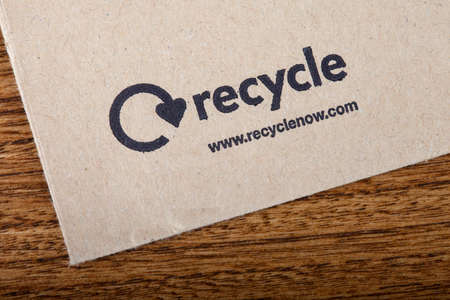 LONDON, UK - JUNE 13TH 2016: Close-up of the official Recycle Now symbol on the back of an envelope, taken in London on 13th June 2016. Recycle Now is a national recycling campaign funded by the government in England.のeditorial素材