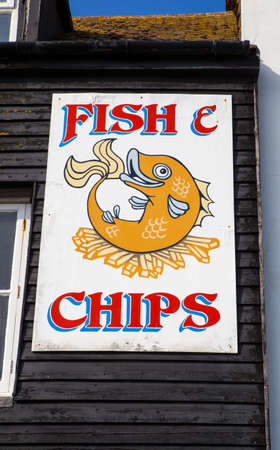 A sign above an eatery selling one of the traditional British dishes of Fish and Chips.のeditorial素材
