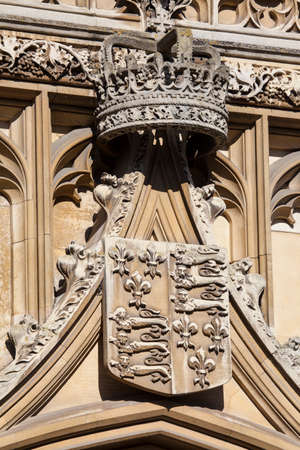 A close-up of the Royal Crown and Coat of Arms on the gatehouse of Kingâs College in Cambridge, UK.のeditorial素材