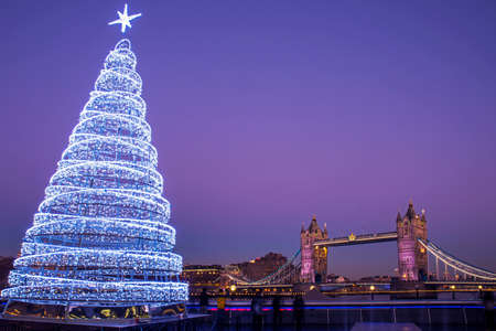 A view of the magnificent Tower Bridge with an illuminated Christmas Tree in London.のeditorial素材