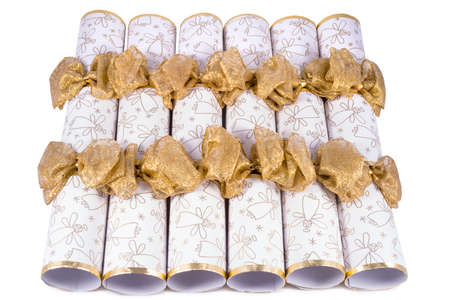 A studio shot of Christmas Crackers or otherwise known as Bon Bons.  A traditional cracker consists of a cardboard tube wrapped in a brightly decorated twist of paper with a gift in the central chamber.の写真素材
