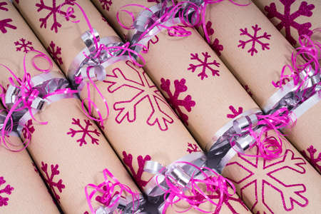 A studio shot of Christmas Crackers or otherwise known as Bon Bons.  A cracker consists of a...