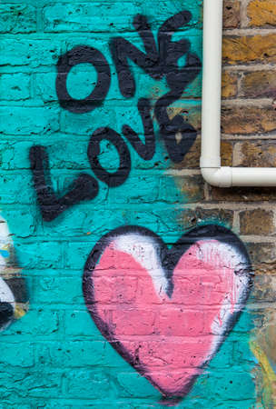 LONDON, UK - JANUARY 13TH 2016: An abstract piece of graffiti on a brick wall symbolising love, on 13th January 2016.のeditorial素材