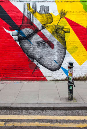LONDON, UK - JANUARY 13TH 2016: Urban Street Art depicting a human heart and an eye, located in East London, on 13th January 2016.のeditorial素材