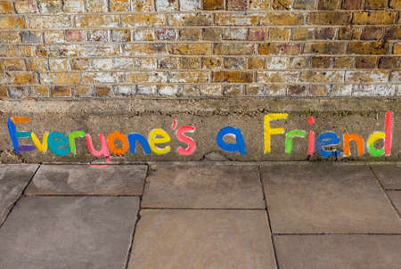 LONDON, UK - JANUARY 13TH 2016: Everyones a Friend colourfullly painted on a brick wall in East London, on 13th January 2016.のeditorial素材