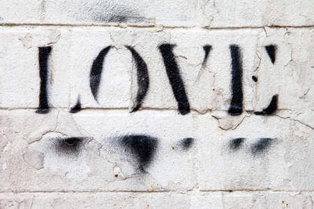 LONDON, UK - JANUARY 13TH 2016: The word LOVE sprayed onto a brick wall in London, on 13th January 2016.のeditorial素材