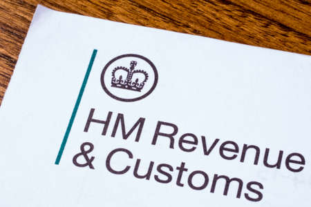 LONDON, UK - JANUARY 13TH 2017: The logo of Her Majestys Revneue and Customs on a piece of paper, on...