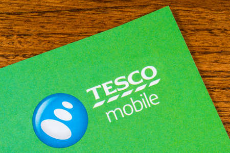 LONDON, UK - JANUARY 13TH 2017: A close-up of the Tesco Mobile logo on a promotional leaflet, on...