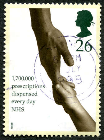 GREAT BRITAIN - CIRCA 1998: A used postage stamp from the UK, detailing the fact that the National Health Service dispense 1.7 million Prescriptions every day, circa 1998.のeditorial素材