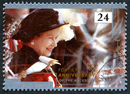 UNITED KINGDOM - CIRCA 1992: A used postage stamp from the UK, commemorating the 40th Anniversary of Queen Elizabeth II accession to the throne, circa 1992.のeditorial素材