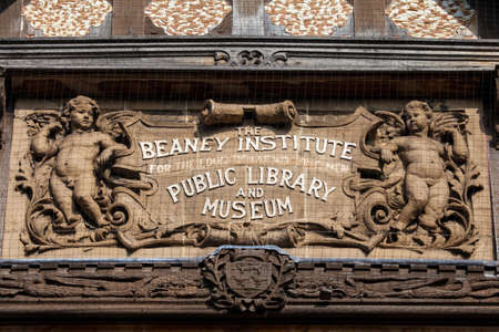 A close-up of the sculptured plaque on the facade of The Beaney House of Art and Knowledge in Canterbury, England.のeditorial素材