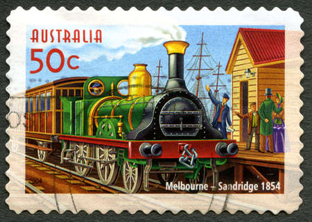 AUSTRALIA - CIRCA 2004: A used postage stamp from Australia, depicting an illustration of an early Steam Engine passenger train that ran between Melbourne and Sandridge, circa 2004.のeditorial素材
