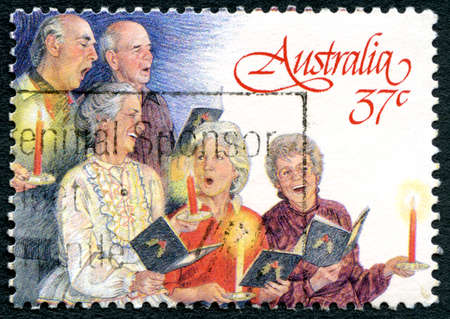 AUSTRALIA - CIRCA 1987: A used postage stamp from Australia, depicting a festive Christmas illustration of Carol Singers, circa 1987.のeditorial素材