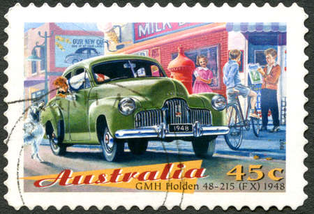 AUSTRALIA - CIRCA 1997: A used postage stamp from Australia, depicting an illustration of a GMH Holden 48-215 (FX) 1948 automobile, circa 1997.のeditorial素材