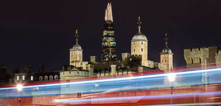 A panoramic night-time view of the Tower of London with the Shard skyscraper in the distance and light trails.のeditorial素材