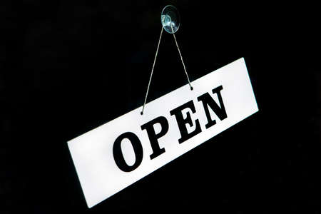 An OPEN sign stuck on a window.