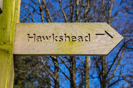 A sign pointing towards the direction of Hawkshead in the Lake District in Cumbria, UK.