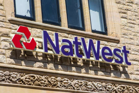 CHICHESTER, UK - APRIL 29TH 2017: The Natwest bank logo above the entrance to one of their branches in Chichester, UK, on 29th April 2017.のeditorial素材