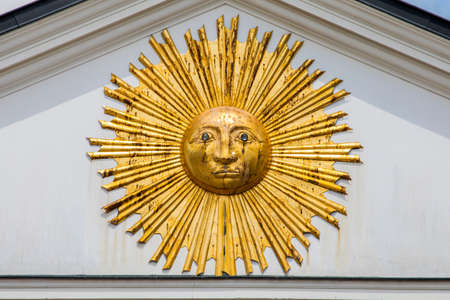 A close-up of a sun sculpture on the exterior of one of the buildings on Grand Place in the historic city of Lille in France.  Possiblly in homage to Louis XIV of France who was known as the Sun King.の写真素材