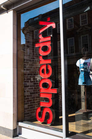 YORK, UK - JULY 18TH 2017: The Superdry logo by the entrance to a Superdry retail store in the city of York in England, on 18th July 2017.のeditorial素材