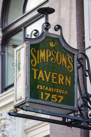 LONDON, UK - AUGUST 25TH 2017: An traditional sign for the historic Simpsons Tavern, established in 1757, located on Ball Court Alley in London, on 25th August 2017.のeditorial素材