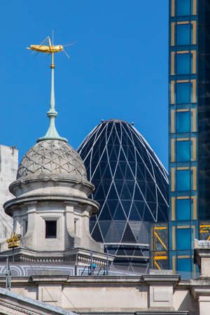 A gold Grasshopper on the Royal Exchange building in London, UK.  The grasshopper was the family emblem of Tudor financier Sir Thomas Gresham who founded the first Royal Exchange in the 16th Century.のeditorial素材