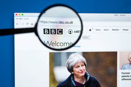 LONDON, UK - JANUARY 8TH 2018: The BBC Logo on the official BBC website magnified under a spy glass,...