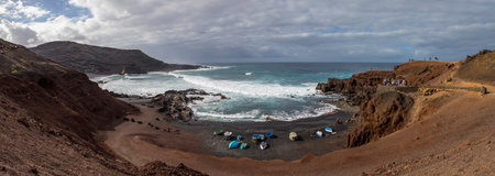 The spectacular view of the crashing waves hitting the coastline at El Golfo on the volcanic island of Lanzarote in Spain.の写真素材