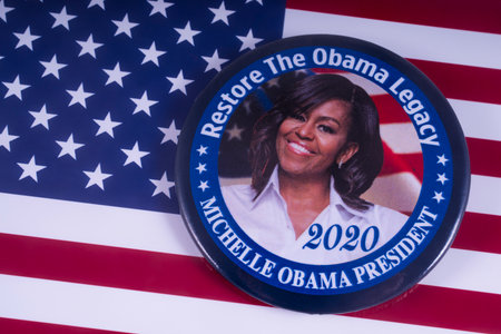 LONDON, UK - MARCH 18TH 2018: A Michelle Obama badge over the USA flag, symbolizing her potential candidacy to run for President in 2020, taken on 18th March 2018.のeditorial素材