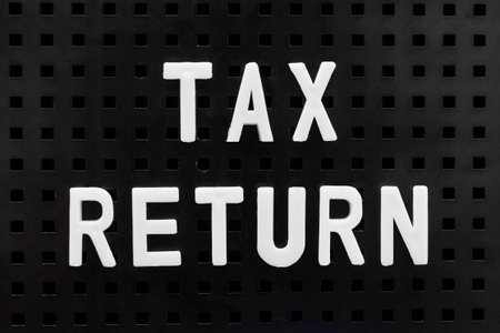 TAX RETURN spelt out on a peg board.の写真素材