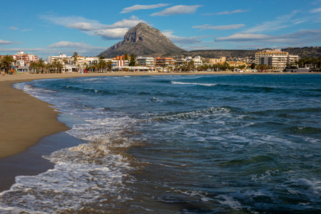 XABIA, SPAIN - APRIL 12TH 2018: A view of the magnificent Arenal beach in Javea, Spain, on 12th April 2018.  Montgo mountain is seen in the distance.  It is also known as Elephant Mountain and Montgo Massif.のeditorial素材
