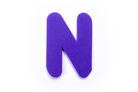 Purple Letter N over a white background.の写真素材