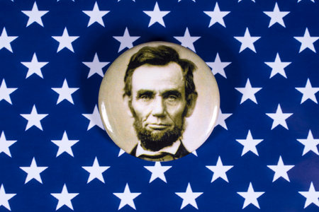 LONDON, UK - APRIL 27TH 2018: An Abraham Lincoln badge pictured over the USA Flag, on 27th April...
