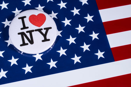 LONDON, UK - APRIL 27TH 2018: An I Love New York badge pictured over the USA flag, on 27th April 2018.のeditorial素材
