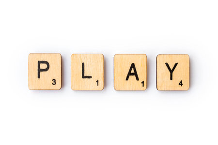 LONDON, UK - JUNE 28TH 2018: The word PLAY spelt out with wooden Scrabble letter tiles, on 28th June 2018.のeditorial素材