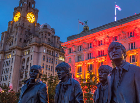 LIVERPOOL, UK - JULY 29TH 2018: Statues of The Beatles - Paul, George, Ringo and John on Pier Head in Liverpool, UK, with the Royal Liver Building in the background, on 29th July 2018.のeditorial素材