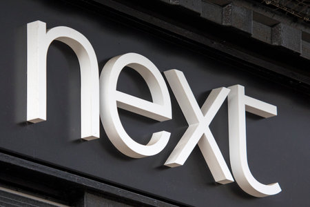 Chester, UK - August 1st 2018: A sign above the entrance to a Next clothing store in the city of Chester, UK.のeditorial素材