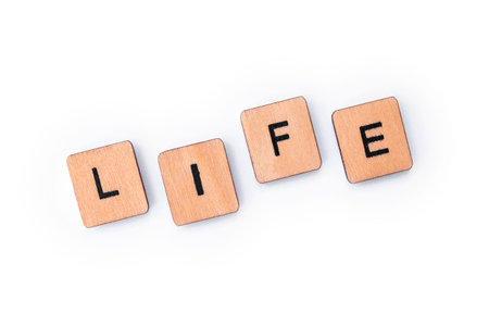 The word LIFE, spelt with wooden letter tiles.の写真素材