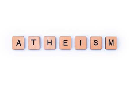 The word ATHEISM, spelt with wooden letter tiles.の写真素材