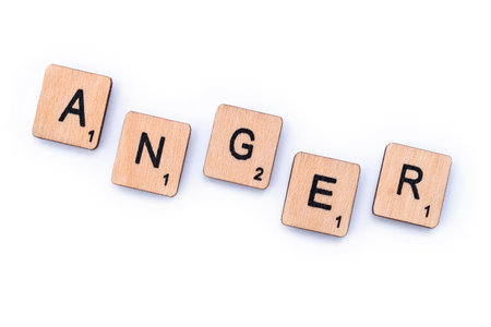 London, UK - February 6th 2019: The word ANGER, spelt out with wooden letter Scrabble tiles.のeditorial素材