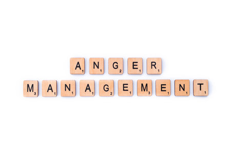 London, UK - February 6th 2019: The phrase ANGER MANAGEMENT, spelt out with wooden letter Scrabble tiles.のeditorial素材