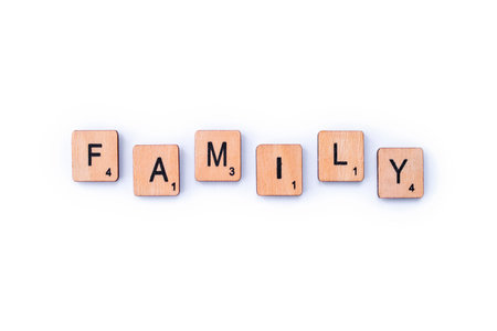 London, UK - February 6th 2019: The word FAMILY, spelt out with wooden letter Scrabble tiles.のeditorial素材