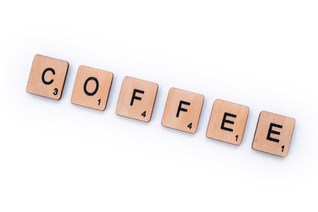 London, UK - March 27th 2019: The word COFFEE, spelt with wooden letter tiles over a white background.のeditorial素材