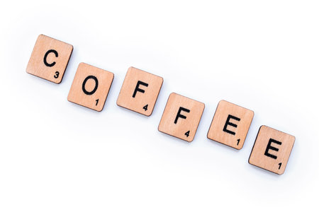 London, UK - March 27th 2019: The word COFFEE, spelt with wooden letter tiles over a white background.のeditorial素材