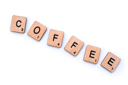 London, UK - March 27th 2019: The word COFFEE, spelt with wooden letter tiles over a white background.のeditorial素材
