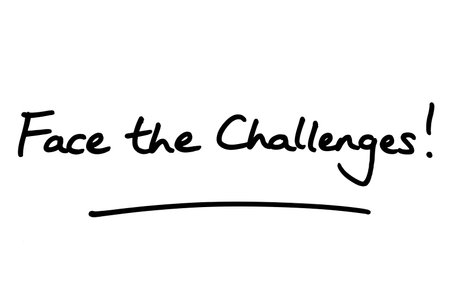 Face the Challenges! handwritten on a white background.の写真素材